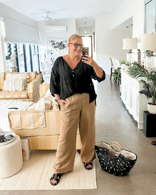 A Black Popover Top With Camel Wide-Leg Pants.