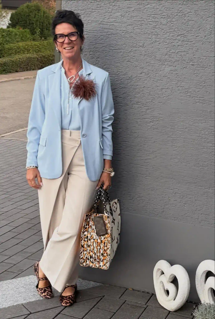 Soft Blue Blazer with Leopard Print Accents and a Playful Brooch.