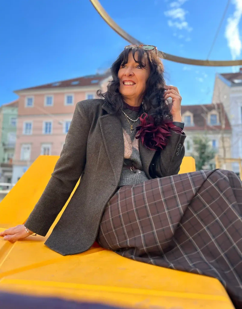 Grey Blazer and Plum Check Trousers with an Oversized Fabric Flower.