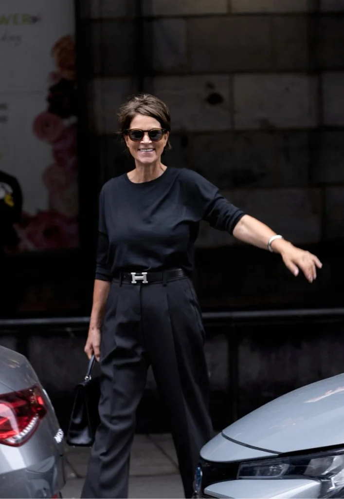 All-Black with a Statement Belt and Tailored Pleated Trousers.